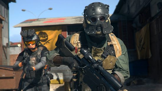 Best Warzone 2 marksman rifles - two soldiers are walking through a warehouse complex, the one in front has a marksman rifle with a scope attached to it.