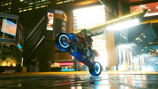 Cyberpunk 2077 vehicle mods: A female V pulls a wheelie in the intersection of two busy downtown streets at night