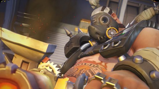 Overwatch 2 tier list: Roadhog wielding his primary weapon as he stares dispassionately at the enemy behind his iconic pig mask.