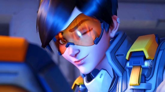 Overwatch 2 Tracer stealth buff - Tracer winking to camera, having placed her pulse bomb against the screen
