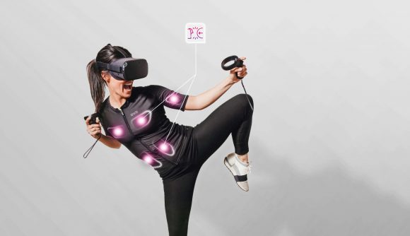 A woman using an OWO Second Skin experiences haptic feedback in VR