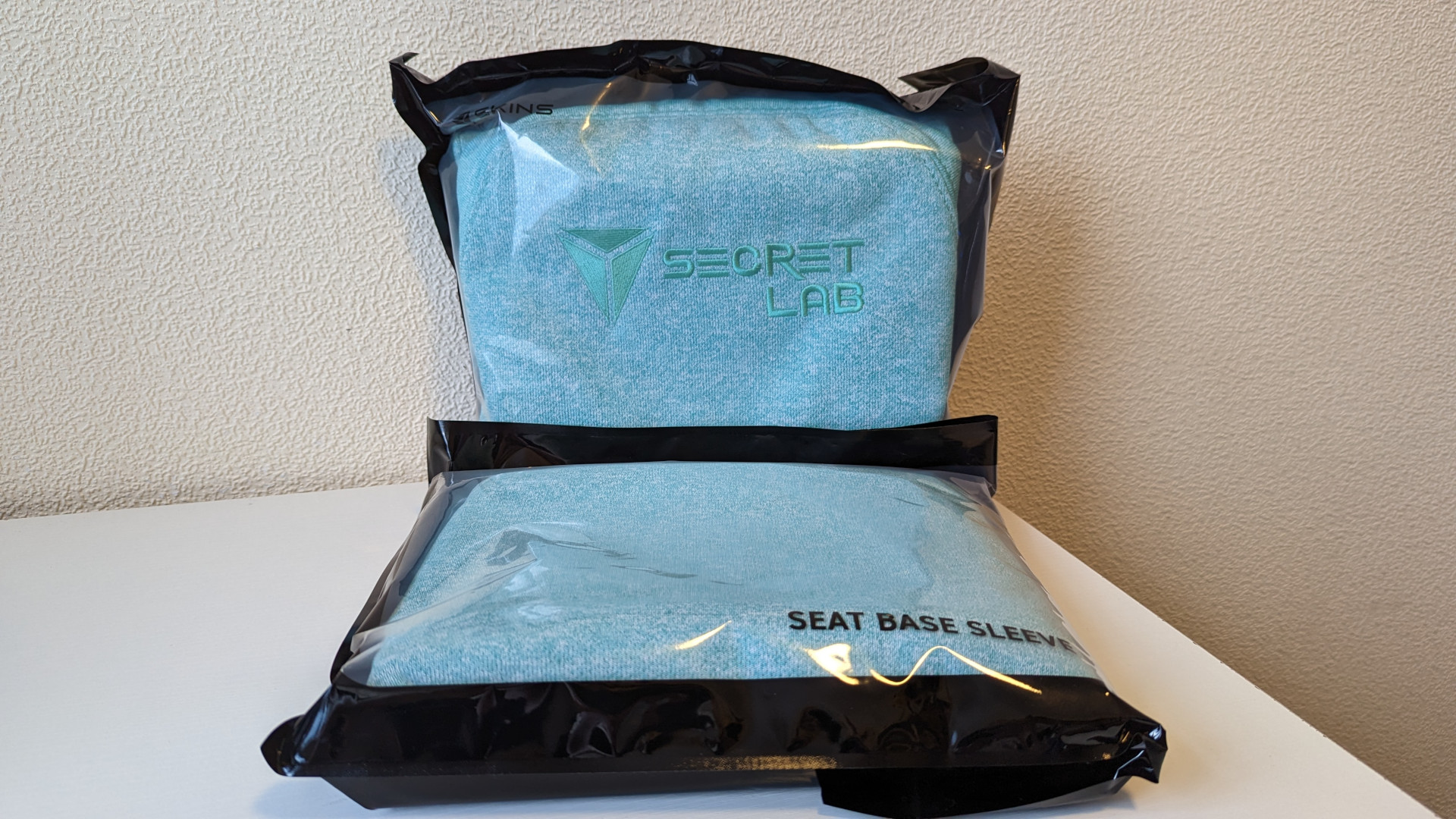 The Secretlab Chair Skin back and base sleeves, in their plastic packaging