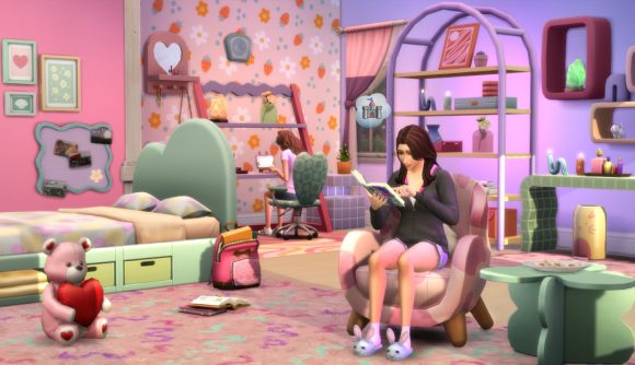 The Sims 4 new kits: A woman reads a book while thinking of a castle and sitting on a rounded seat in a pink-themed bedroom, and a roommate sits at a desk in the background facing the floral-print wall