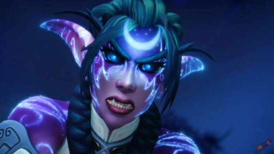 An elf woman with a glowing crescent moon tattoo on her forehead and green hair bears her teeth and growls into the camera on a midnight background