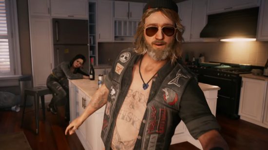 Dead Island 2 gameplay video: A pair of aging bikers sits in a well-appointed, modern kitchen - the man has a beard and long sandy hair, and wears an open motorcycle jacket, aviator shades, and a winter knit cap