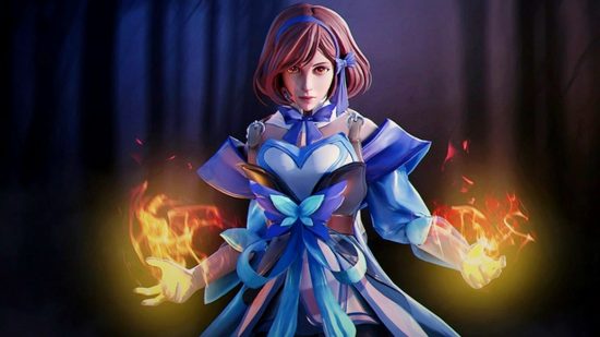 Dota 2 collector's cache 2 finally unveiled after concerns: A woman in a blue and white dress stands on a forest background holding two fireballs in her hands