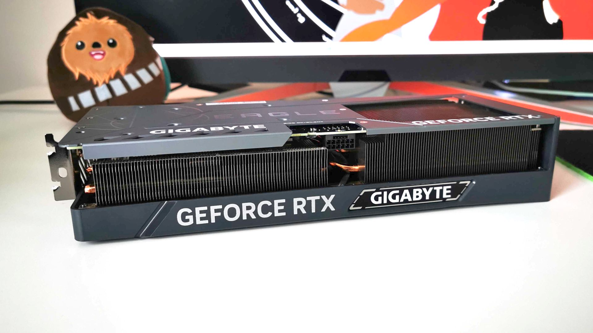 Nvidia RTX 4070 Ti review: graphics card on white surface with Wookiee plush in backdrop