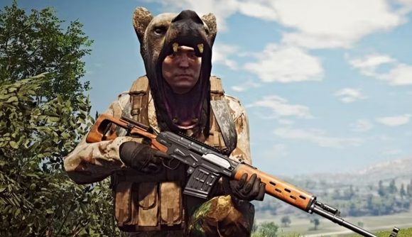 Old School RuneScape studio Jagex acquires Scum dev Gamepires: A man wearing a bear head as a hat stands in an idyllic country area holding a sniper rifle