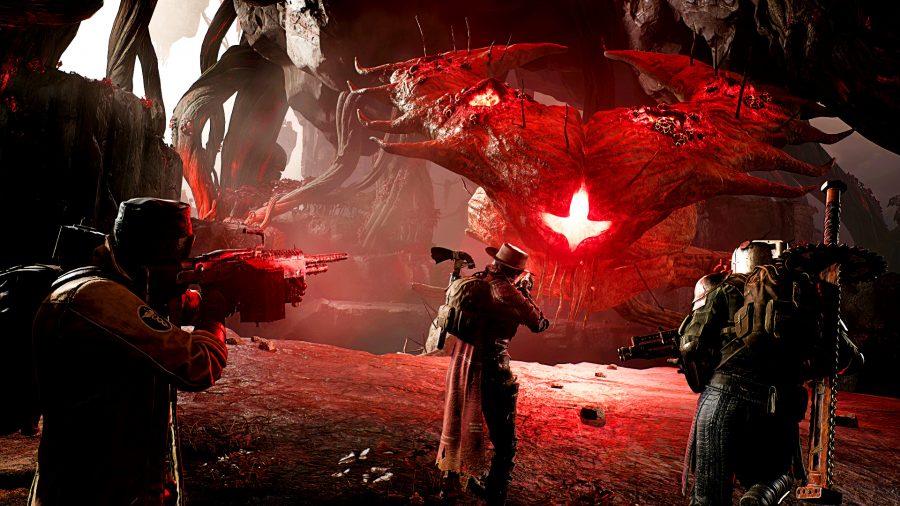 Remnant 2 - three figures shoot at a giant, alien-like creature with a glowing red face