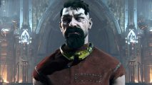 Warhammer 40k Darktide hotfix: A 'reject' stands in red prison dungarees and a metal yellow collar, he is older and scarred, with a brown beard and hastily cut hair