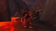 WoW Dragonflight leveling guide: A character stood near some lava facing the camera