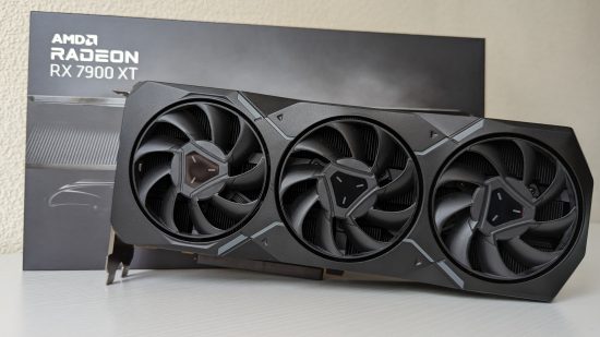 The AMD Radeon RX 7900 XT graphics card sits in front of its retail packaging