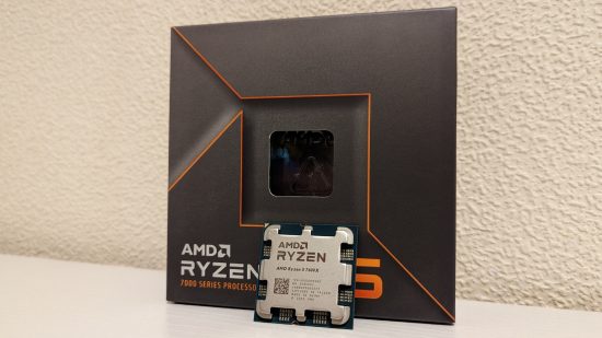 The AMD Ryzen 5 7600X CPU, leaning against its retail packaging