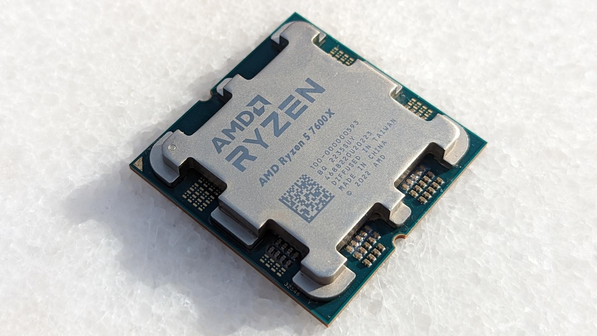 AMD Ryzen 5 7600X CPU lying on a white stone table