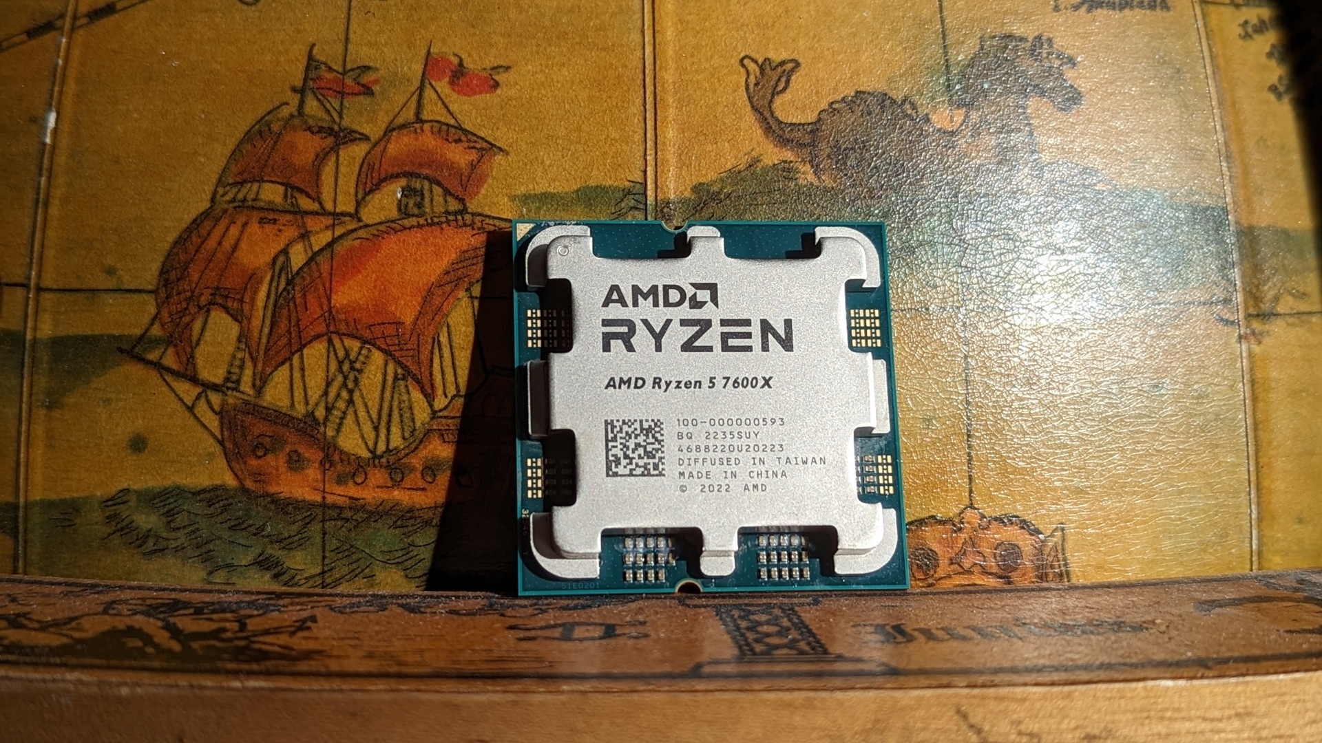 The AMD Ryzen 5 7600X against a globe of drinks