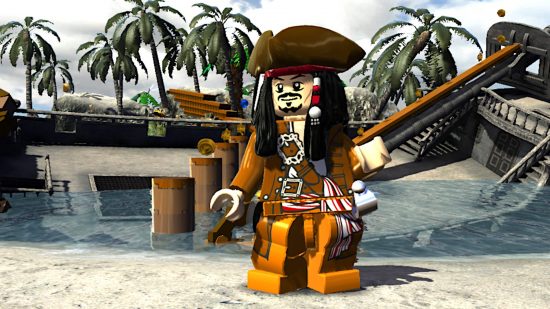 Best Pirate games: a Lego version of Captain Jack Sparrow, standing next to a sunken ship in Lego Pirates of the Caribbean.