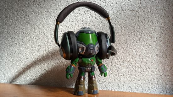 Best wireless gaming headset: A Slayer toy from Doom, wearing a pair of headphones, against a white backdrop