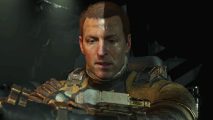 Dead Space Remake Indecipherable text log - Isaac Clarke looks at a display on his forearm as a shadow falls across his face