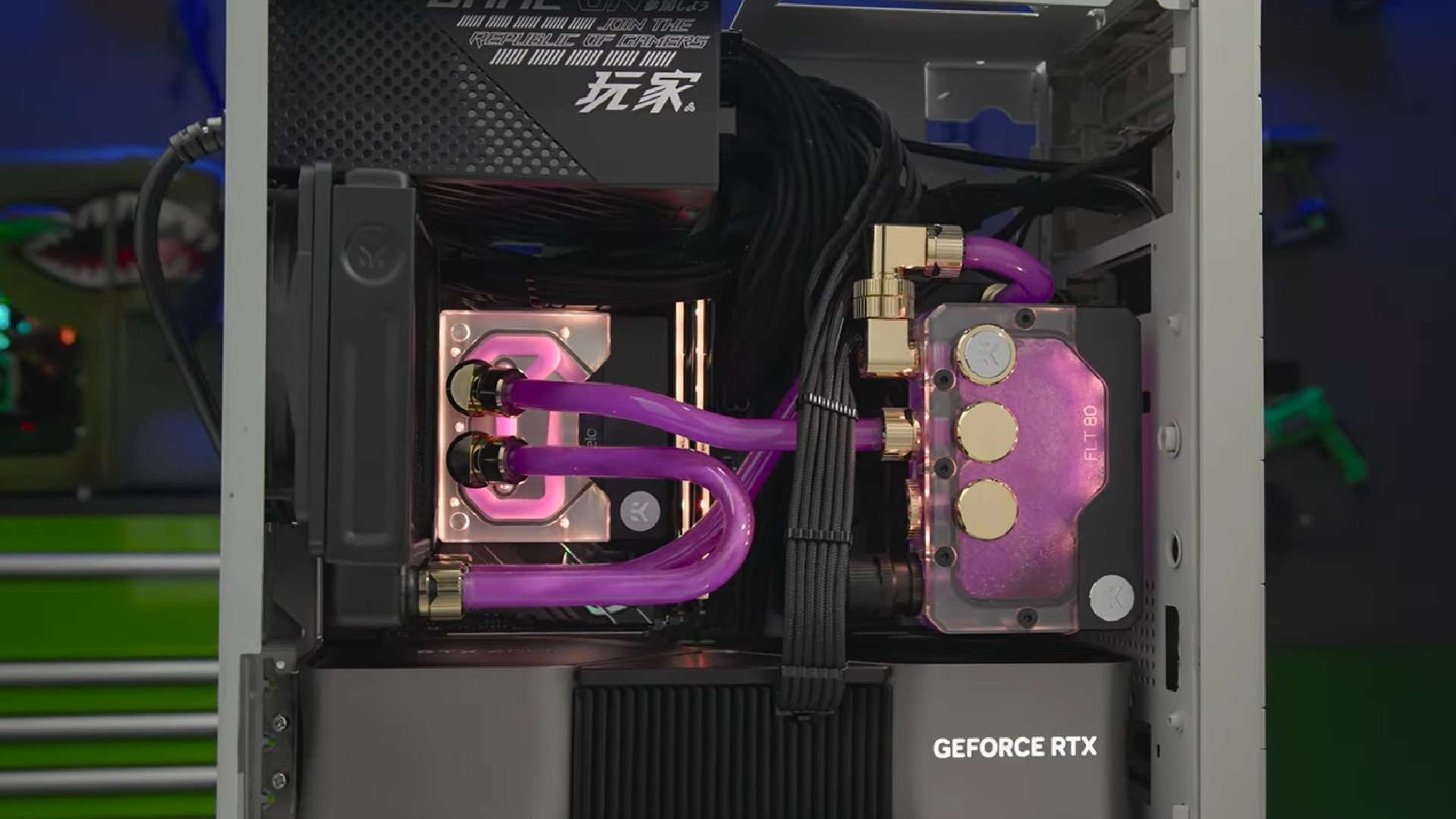 Inside Nvidia GeForce Garage sleeper RTX 4090 gaming PC with purple AIO cooler and graphics card on bottom