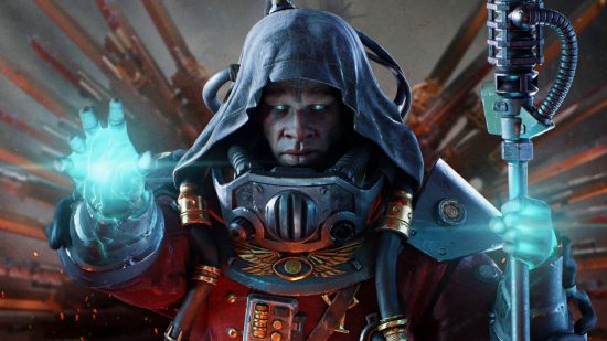 Darktide patch notes PSA: Third-party tools are risky business: A dark skinned man with glowing aqua eyes wearing a hood and red machine armour looks into the camera holding a staff and a blue orb