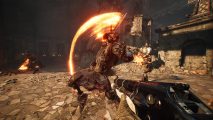Witchfire gameplay trailer: an armoured skeleton winds up to attack a player holding an arcane blunderbuss in a ruined castle