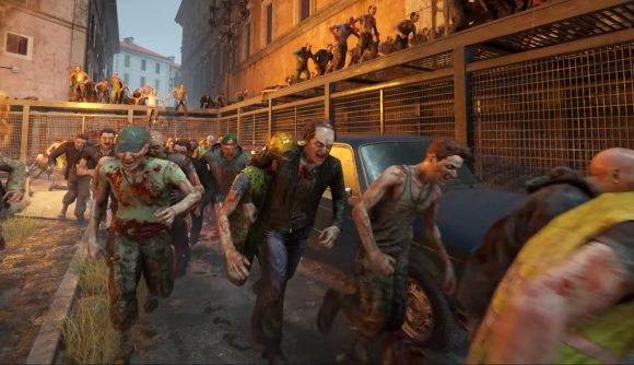 World War Z Aftermath zombie hordes: A swarm of zombies rushes down a ruined city street lined with fences and destroyed cars