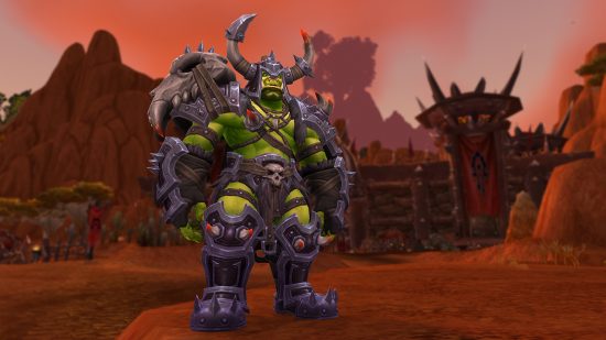 A green orc standing in a barren red wasteland wearing hulking black, spiked armour and a helmet with two long horns
