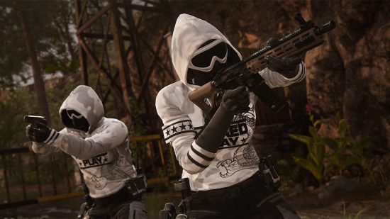 Call of Duty Modern Warfare 2 ranked: Two figures in white hoodies and paintball masks and goggles move through the woods with their firearms at the ready position
