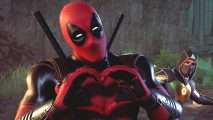 The superhero Deadpool, makes a heart sign with his hands