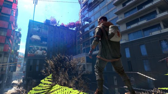 Dying Light 2 weapon stash hotfix: Aiden stands on a tall building looking out over ruined streets toward several glass-sheathed skyscrapers, all abandoned