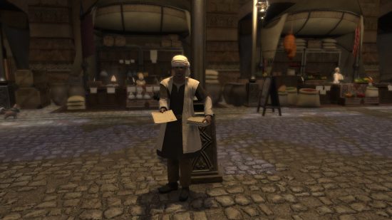 A man in a white turban and long white coat handing out a flier in a cobbled street
