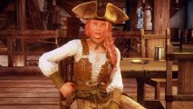 New World season pass price may shock, but Amazon says it's worth it: A ginger white woman in a leather pirate hat and traditional pirate dress looks into the camera sitting on a wooden chair in a tavern with her left hand on her hip
