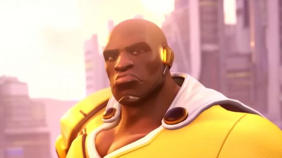 Overwatch 2 One Punch Man crossover is real, and it's amazing: a man looks at the camera with a determined look on his face, wearing a yellow shirt and white cape