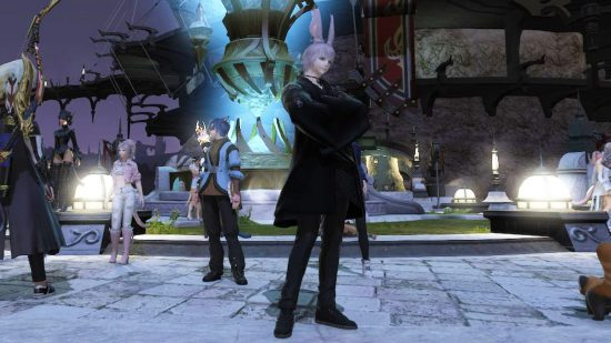 An anime man with huge pink bunny ears and pink hair stands with his arms folded wearing an all black outfit in front of a huge blowing blue crystal