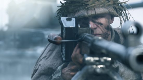 Best war games on PC: a soldier looks past the camera as he aims his LMG.