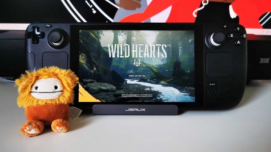 Wild Hearts Steam Deck: Valve';s handheld with game title on screen and monster plush on left