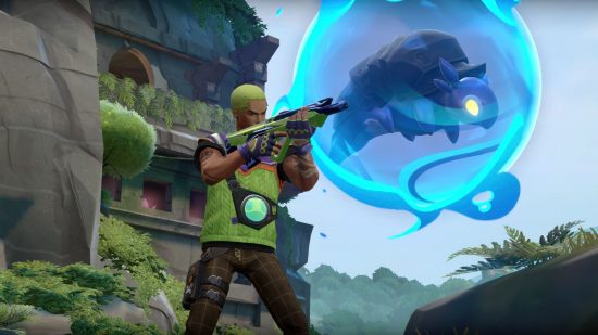 A young latino man with bright green hair sands holding a gun wearing a green tactical vest with a blue turtle creature floating next to him in a blue aura