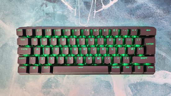 Corsair K70 Pro Mini Wireless review: A top-down view of the wireless gaming keyboard, with its RGB LEDs set to green