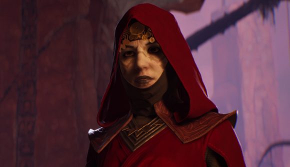 Star Wars Jedi Fallen Order now costs less than Grogu's favourite soup: A pale woman wearing a red hooded cloak and a black mask below her chin looks into the camera