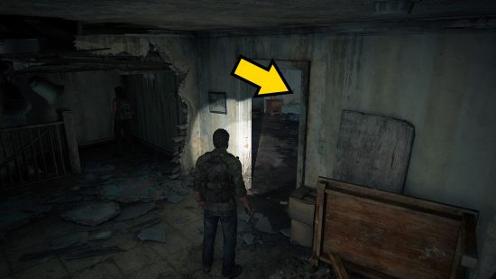 The Last of Us Firefly Pendants locations: a man in a dark, delapidated room pointing a flashlight at a door.