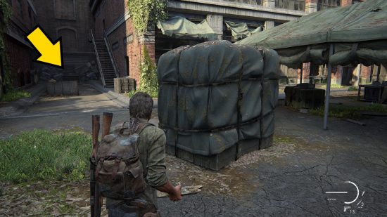 The Last of Us Firefly Pendants locations: a man stands in front of a large, wrapped container.
