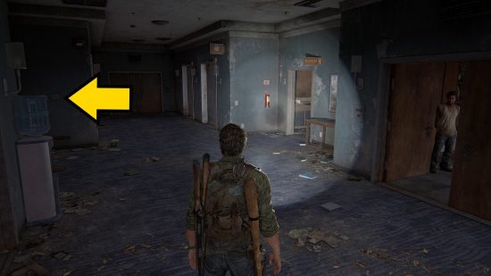 The Last of Us Firefly Pendants locations: a man shines his flashlight down a dark corridor.