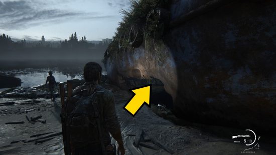 The Last of Us Firefly Pendants locations: man shines his flashlight on a natural wall.