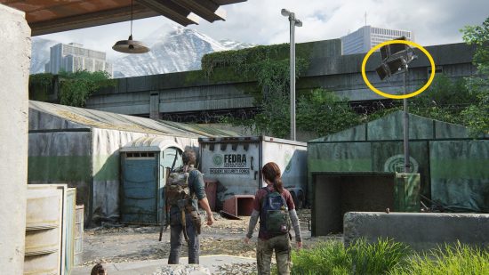 The Last of Us Firefly Pendants locations: a man and young woman look at an abandoned facility.