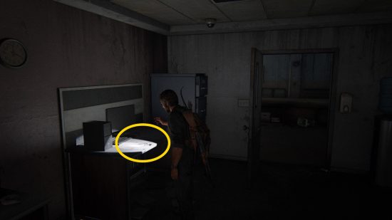 The Last of Us Firefly Pendants locations: a dark hospital room lit only by a man's flashlight.