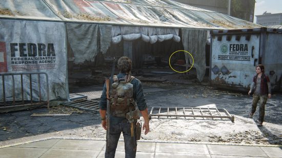 The Last of US workbench tool locations: a man looks at a broken down and ripped white tent.