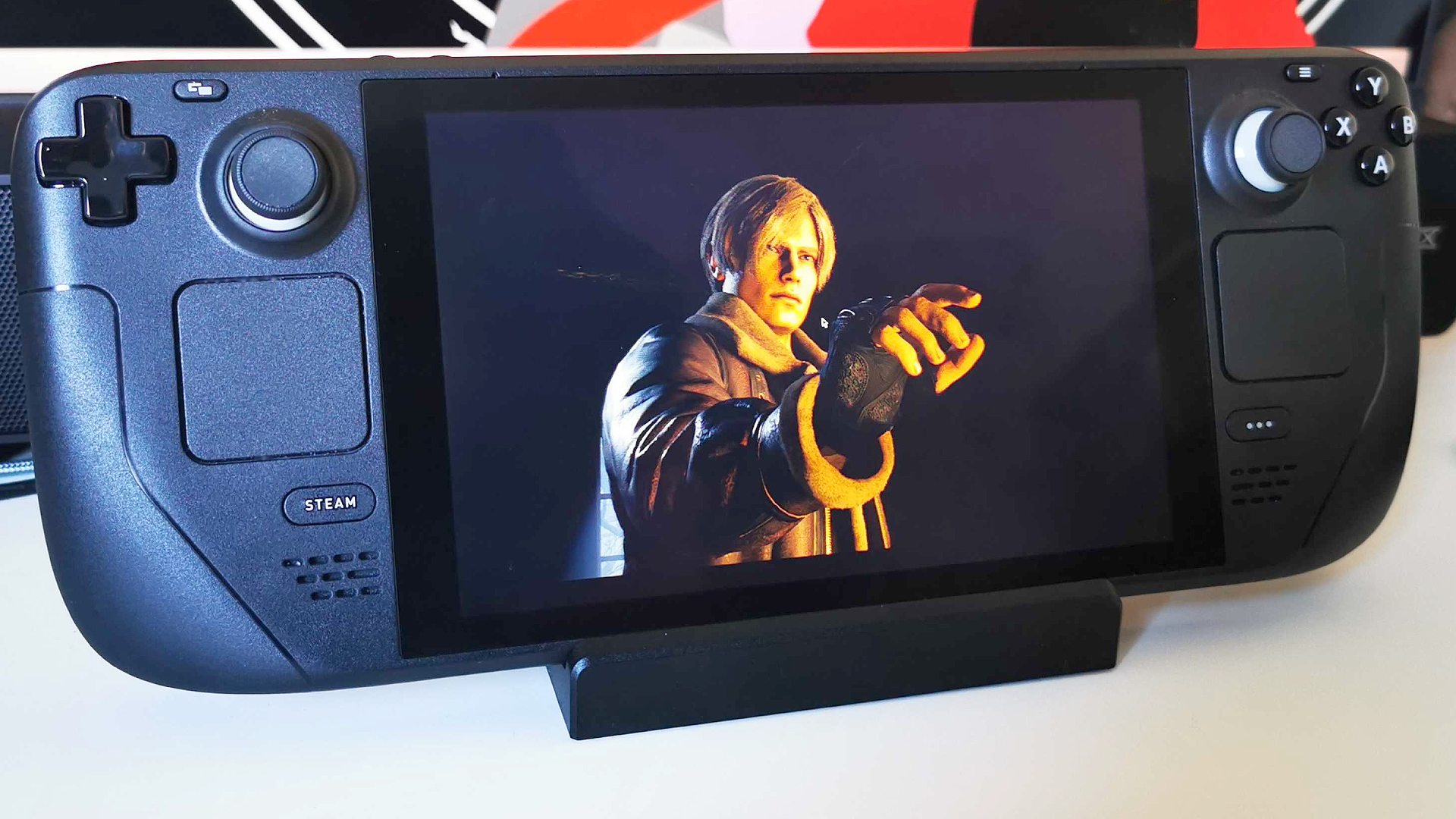 Valve Steam Deck dock review: Hanheld PC on docking station with Leon Kennedy from Resident Evil 4 Remake on screen
