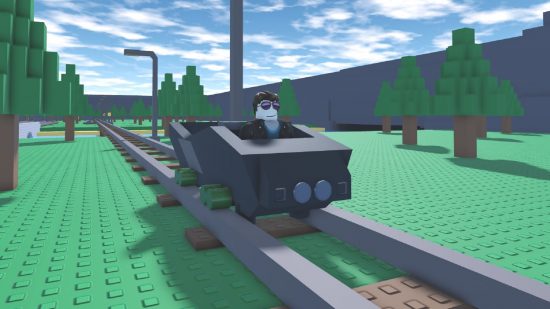A coal miner tycoon rides his minecart along a track surrounded by green grass and trees.