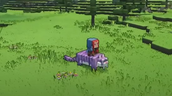 Minecraft Legends mounts: The player sits astride a sabertooth tiger in the middle of a green meadow dotted with colourful flowers.