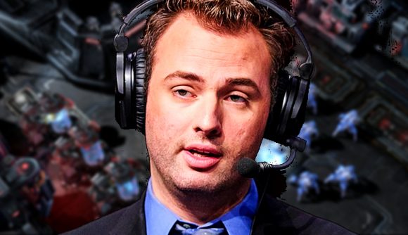 Starcraft commentator Sean 'Day[9]' Plott wearing a suit and headset, in front of a screenshot from StarCraft II: Legacy of the Void